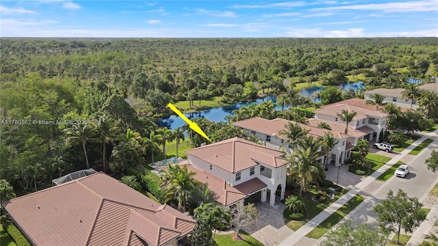 aerial view with a water view and a forest view