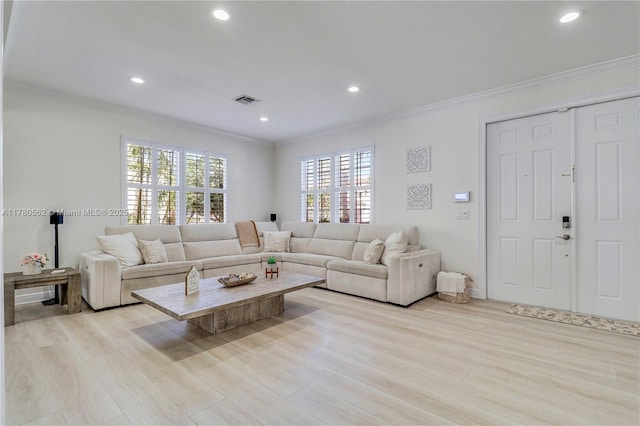 living room featuring crown molding, visible vents, and recessed lighting