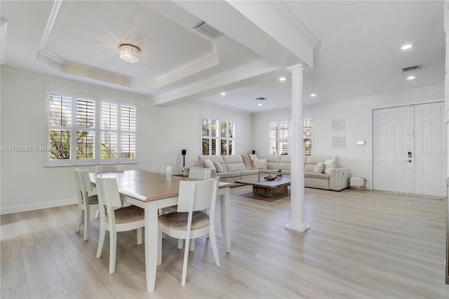 dining room with decorative columns, visible vents, and crown molding