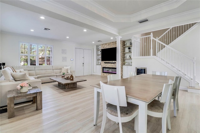 dining area with ornamental molding, recessed lighting, stairway, and light wood-style floors