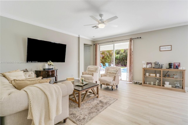 living room featuring visible vents, baseboards, ceiling fan, light wood-style floors, and crown molding