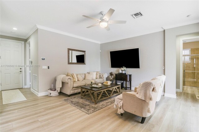 living area with light wood-style flooring, baseboards, and visible vents