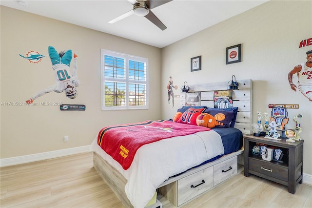 bedroom with light wood-type flooring, baseboards, and a ceiling fan