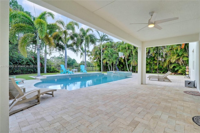 view of swimming pool with a patio area, a fenced backyard, ceiling fan, and a pool with connected hot tub