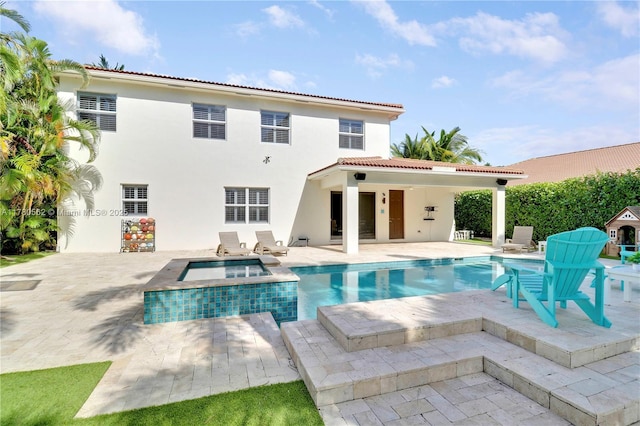 back of property featuring stucco siding, an in ground hot tub, an outdoor pool, a patio area, and a tile roof