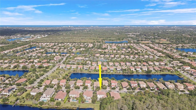 drone / aerial view featuring a water view and a residential view