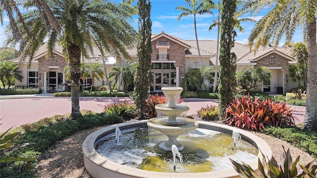 view of community featuring a garden pond