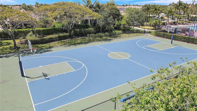 view of basketball court with community basketball court and fence