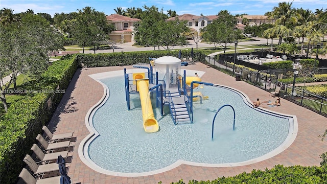 view of property's community with fence and playground community