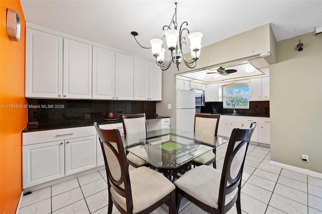 5300 Washington St Unit G323, Hollywood, FL 33021 - dining space featuring a chandelier, light marble finish floors, and a ceiling fan