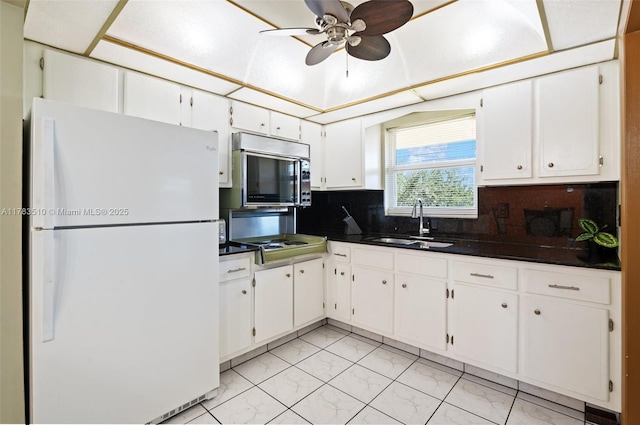5300 Washington St Unit G323, Hollywood, FL 33021 - kitchen featuring freestanding refrigerator, stainless steel microwave, a sink, dark countertops, and light marble finish floors