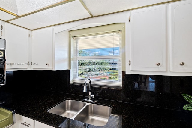 5300 Washington St Unit G323, Hollywood, FL 33021 - kitchen with a sink, white cabinets, decorative backsplash, and dark stone counters