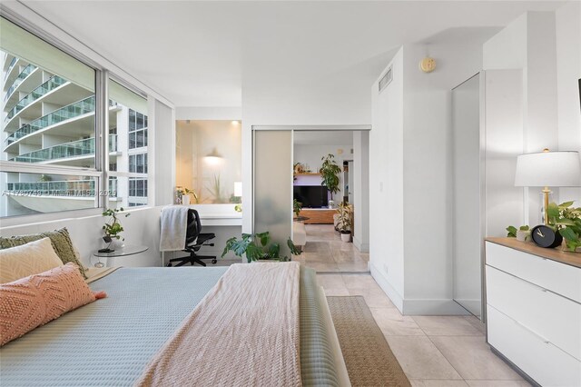 1500 Bay Rd Unit 668S, Miami Beach, FL 33139 - bedroom featuring a closet, light tile patterned floors, visible vents, and baseboards