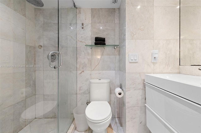 1500 Bay Rd Unit 668S, Miami Beach, FL 33139 - full bathroom featuring a shower stall, tile walls, vanity, and toilet