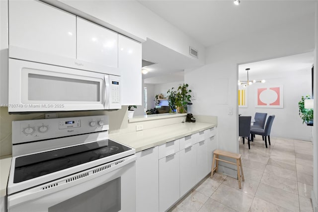 1500 Bay Rd Unit 668S, Miami Beach, FL 33139 - kitchen featuring white appliances, white cabinetry, a chandelier, light countertops, and modern cabinets