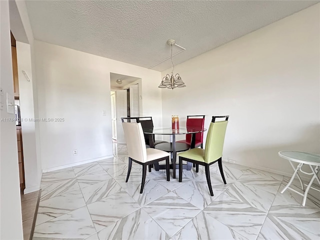 569 N Fanshaw N Unit 569, Boca Raton, FL 33434 - dining space with a textured ceiling and a chandelier