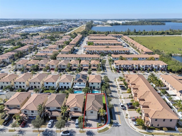 drone / aerial view featuring a water view and a residential view
