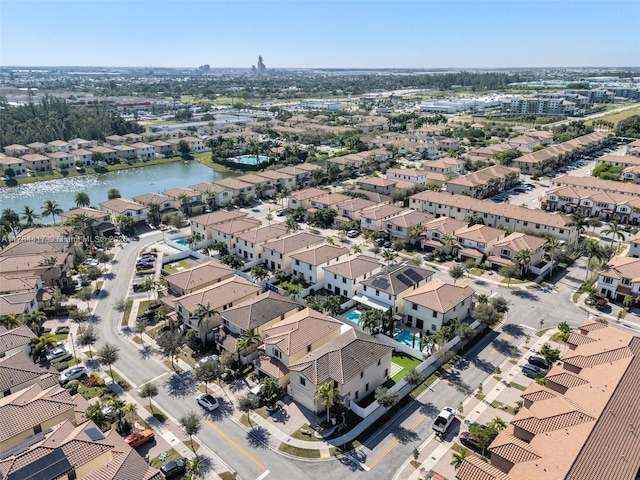 drone / aerial view featuring a residential view and a water view