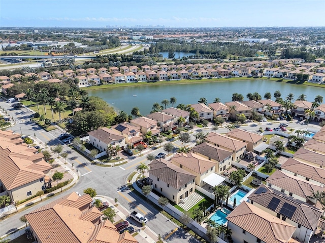 drone / aerial view with a residential view and a water view
