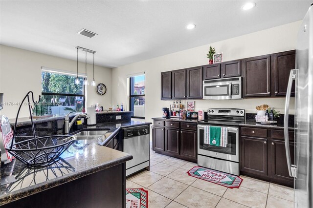 kitchen with a sink, a wealth of natural light, visible vents, and stainless steel appliances