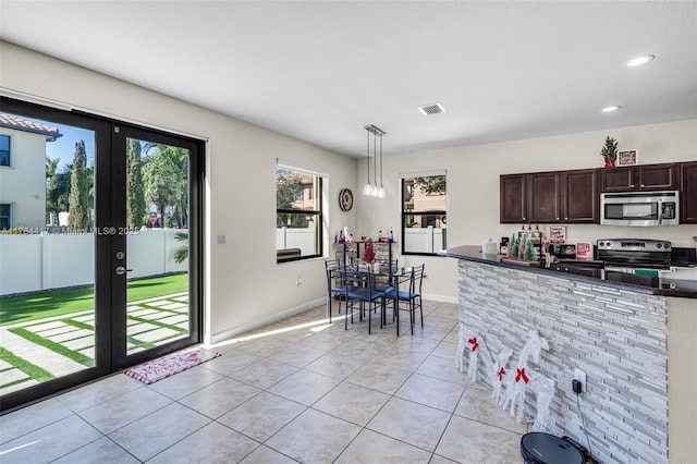 kitchen with french doors, dark brown cabinets, light tile patterned flooring, visible vents, and appliances with stainless steel finishes