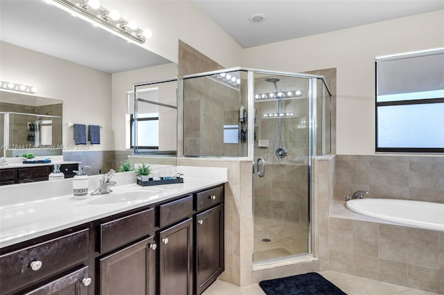 bathroom featuring a shower stall, tile patterned floors, vanity, and a garden tub