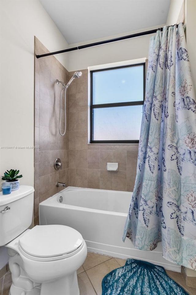 bathroom with tile patterned floors, shower / tub combo, and toilet