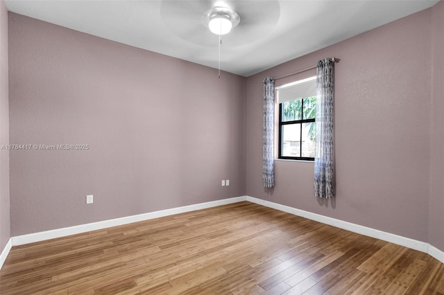 empty room with light wood-style floors, ceiling fan, and baseboards