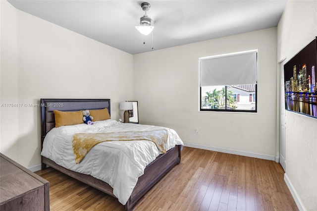 bedroom featuring wood finished floors, ceiling fan, and baseboards