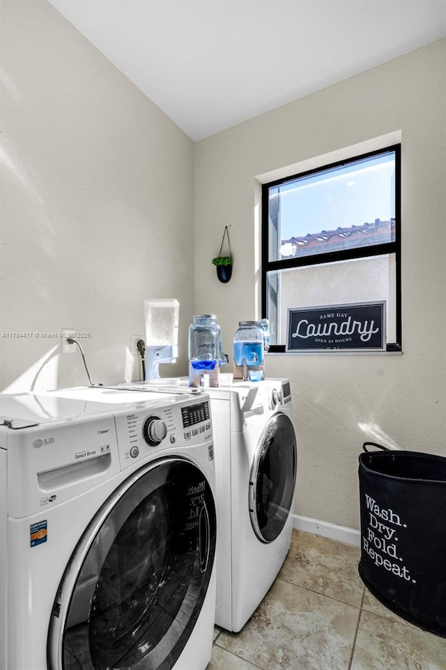 laundry area featuring baseboards, washing machine and dryer, and laundry area