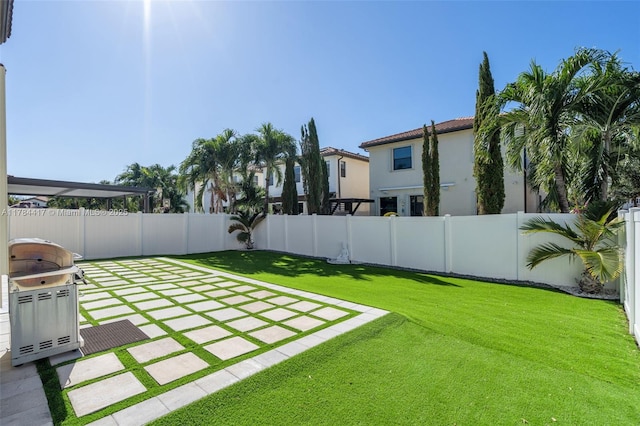 view of yard featuring a patio area and a fenced backyard