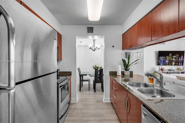 1200 Brickell Bay Dr Unit 1723, Miami, FL 33131 - kitchen featuring light wood-style floors, a textured ceiling, visible vents, a sink, and stainless steel appliances