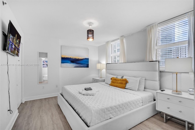 1200 Brickell Bay Dr Unit 1723, Miami, FL 33131 - bedroom with light wood-style flooring and baseboards