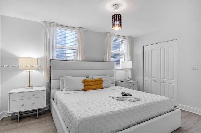 1200 Brickell Bay Dr Unit 1723, Miami, FL 33131 - bedroom with a closet, multiple windows, baseboards, and wood finished floors