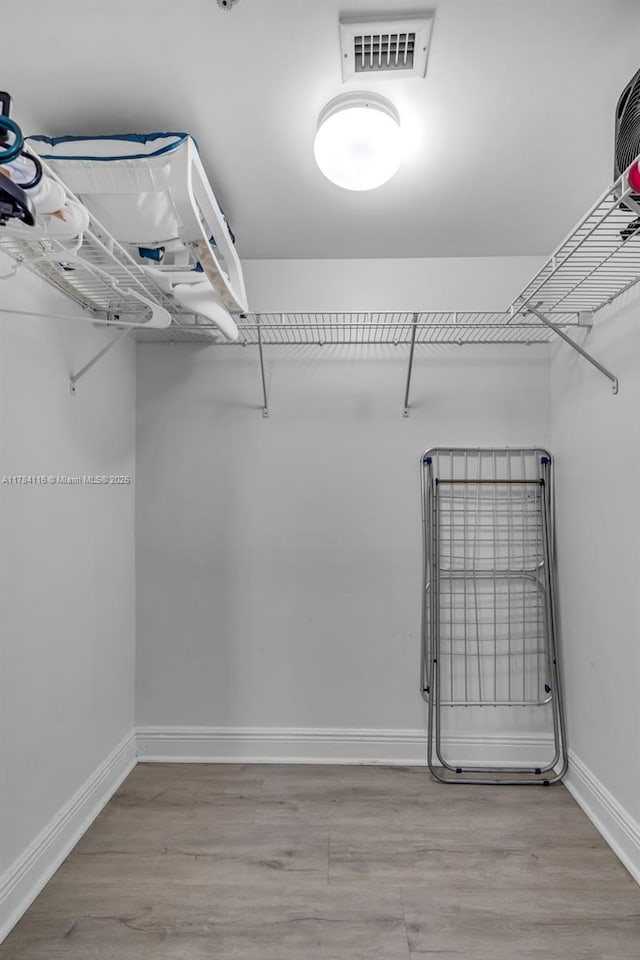 1200 Brickell Bay Dr Unit 1723, Miami, FL 33131 - spacious closet with visible vents and wood finished floors