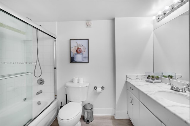 1200 Brickell Bay Dr Unit 1723, Miami, FL 33131 - full bath featuring combined bath / shower with glass door, vanity, baseboards, toilet, and wood finished floors