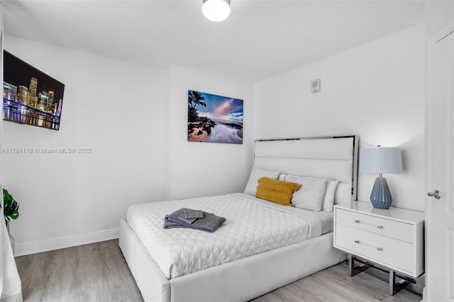 1200 Brickell Bay Dr Unit 1723, Miami, FL 33131 - bedroom featuring baseboards and wood finished floors