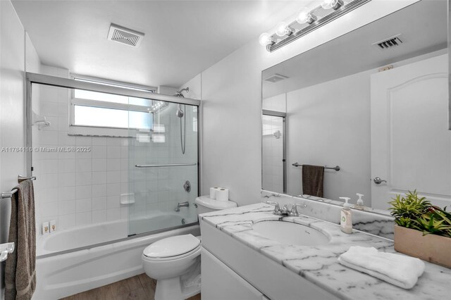 1200 Brickell Bay Dr Unit 1723, Miami, FL 33131 - full bath with vanity, visible vents, toilet, and wood finished floors