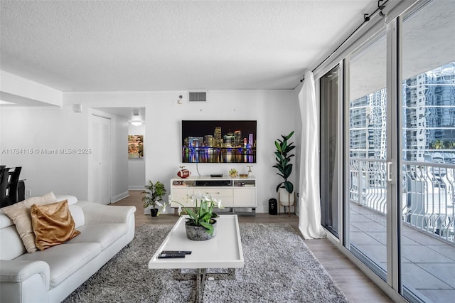 1200 Brickell Bay Dr Unit 1723, Miami, FL 33131 - living area with light wood-style floors, visible vents, and a textured ceiling