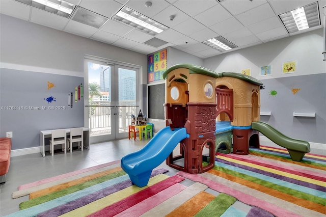 1200 Brickell Bay Dr Unit 1723, Miami, FL 33131 - rec room featuring french doors, baseboards, a drop ceiling, and visible vents