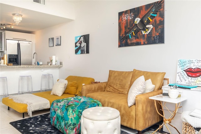 tiled living area featuring a sink and visible vents