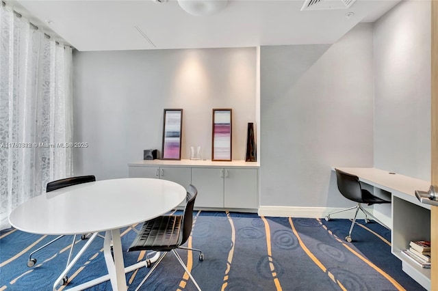carpeted home office with baseboards and visible vents