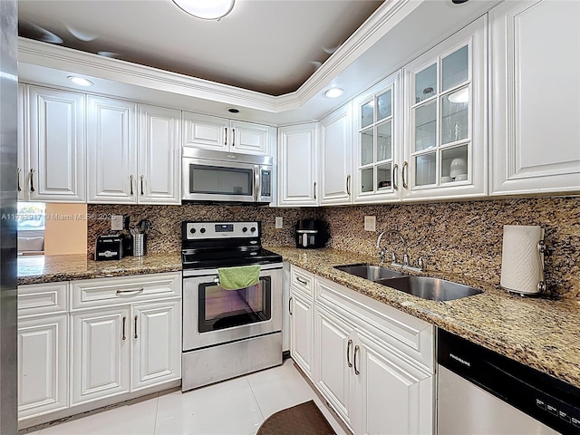 1913 S Ocean Dr Unit 110, Hallandale Beach, FL 33009 - kitchen featuring white cabinets, stainless steel appliances, a sink, backsplash, and light tile patterned floors