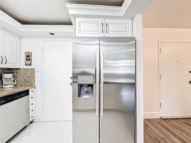 1913 S Ocean Dr Unit 110, Hallandale Beach, FL 33009 - kitchen with white cabinets, a raised ceiling, dishwashing machine, ornamental molding, and stainless steel fridge