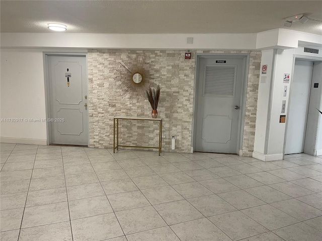 1913 S Ocean Dr Unit 110, Hallandale Beach, FL 33009 - interior space featuring elevator, light tile patterned floors, and baseboards