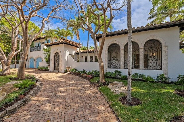 551 S Mashta Dr, Key Biscayne, FL 33149 - mediterranean / spanish-style home featuring a tiled roof, stucco siding, and decorative driveway