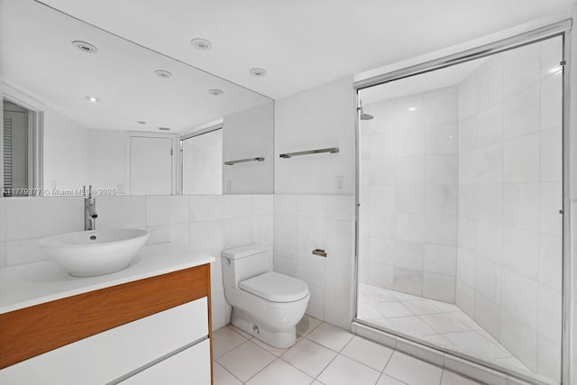 1121 Crandon Blvd Unit F702, Key Biscayne, FL 33149 - bathroom with tile walls, toilet, vanity, a tile shower, and tile patterned flooring