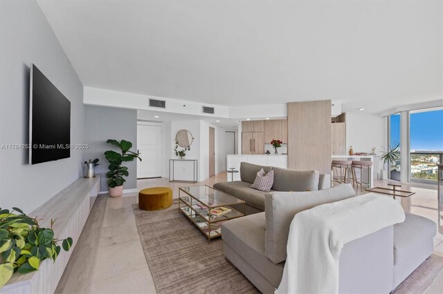 7330 Ocean Ter Unit 20-B, Miami Beach, FL 33141 - living room featuring light tile patterned floors, expansive windows, and visible vents