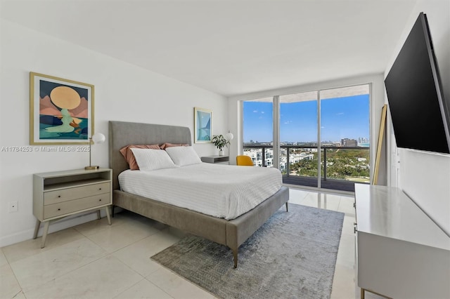 7330 Ocean Ter Unit 20-B, Miami Beach, FL 33141 - bedroom with light tile patterned floors, a wall of windows, and baseboards