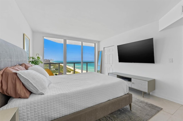 7330 Ocean Ter Unit 20-B, Miami Beach, FL 33141 - bedroom featuring a wall of windows, visible vents, tile patterned flooring, and baseboards